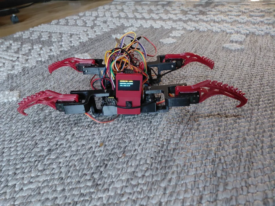 The early red printed robot on the carpet, with its mechanisms and wiring visible.